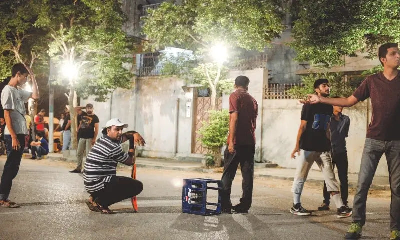 People Enjoying box cricket in the streets