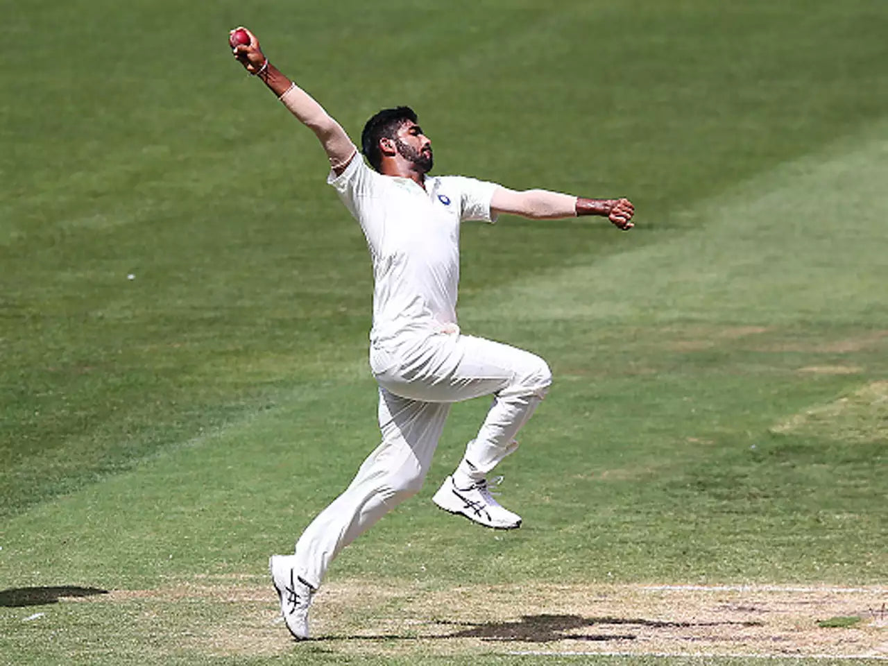 Jasprit Bumrah takes a jump and performs hi bowling action before delivering a ball