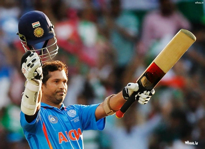 Sachin Tendulkar raises his bat and helmet to Celebrate his century in an ODI game