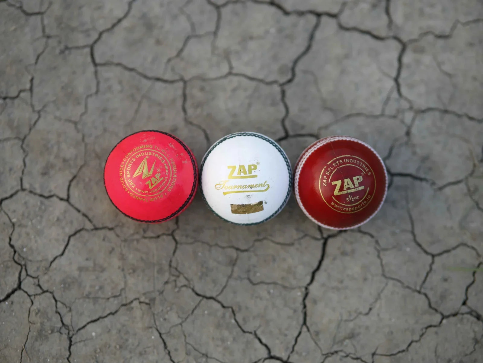 The Pink, White and Red ZAP Leather Cricket Balls Placed beside one another