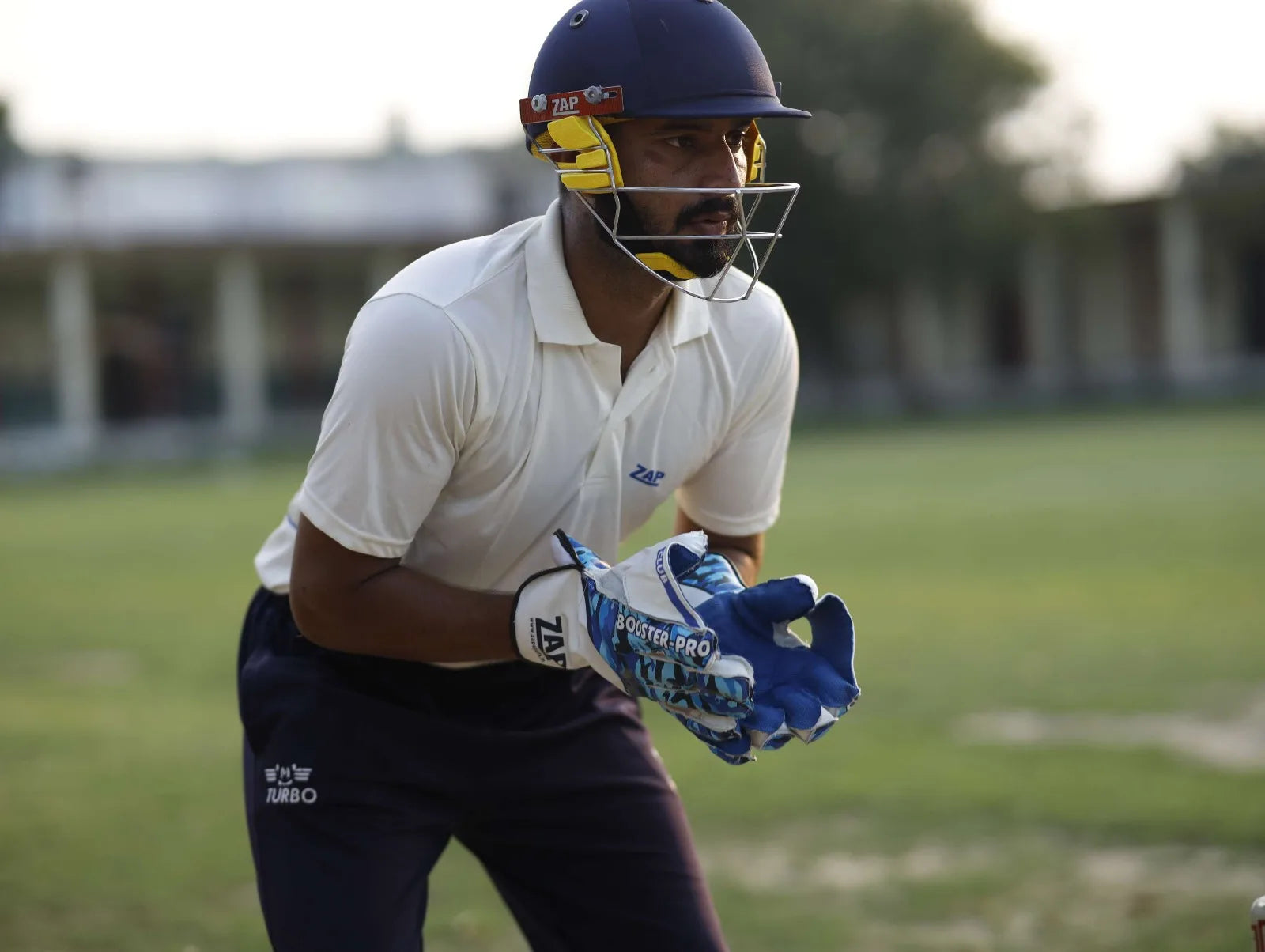 A ZAP Wicket Keeper concentrates at the bowlers, ready to show class with the ZAP Wicket keeping gloves behind the stumps