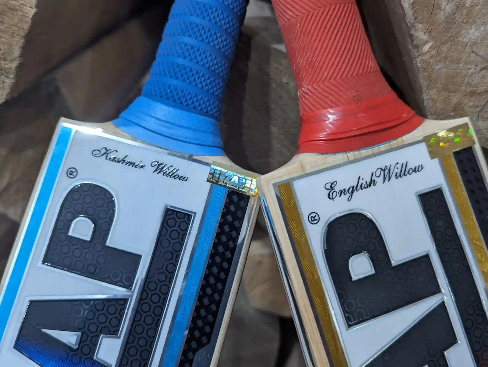 A ZAP Kashmir Willow and English Willow Cricket Bat leaning into each other