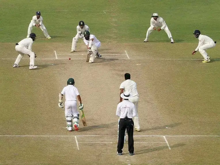 Hashim Amla surrounded by a silly point, the short leg, the slips in a test match against India