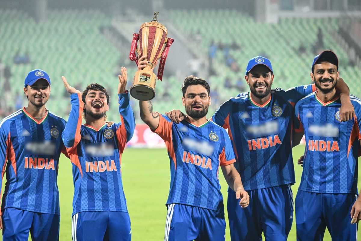 Rinku Singh holding trophy with his teammates 