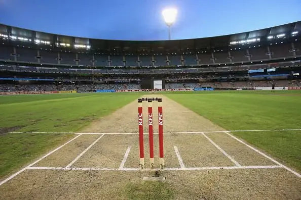 A photo of a cricket pitch at the middle of a stadium