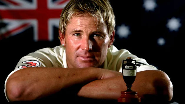 Shane Warne poses with the Ashes urn