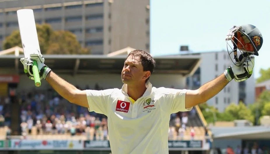 Ricky Ponting raises his bat to celebrate a century