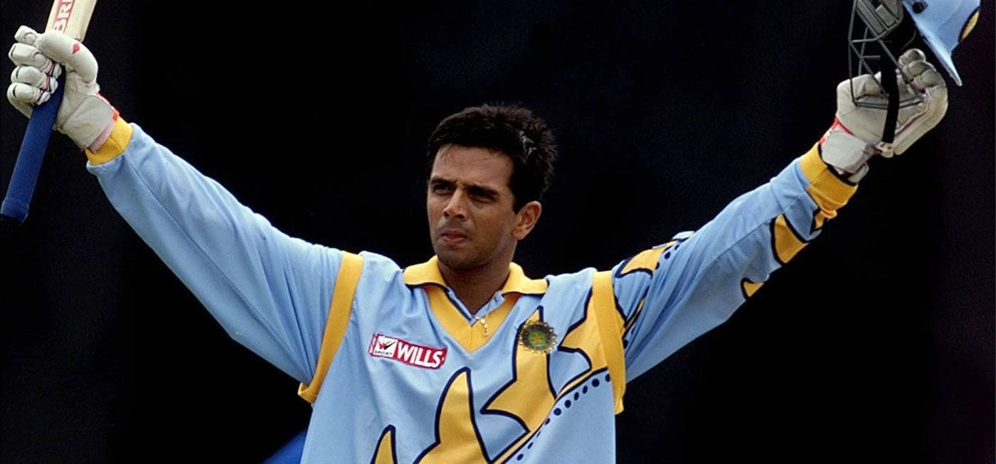 Rahul Dravid raises his bat to celebrate an ODI century